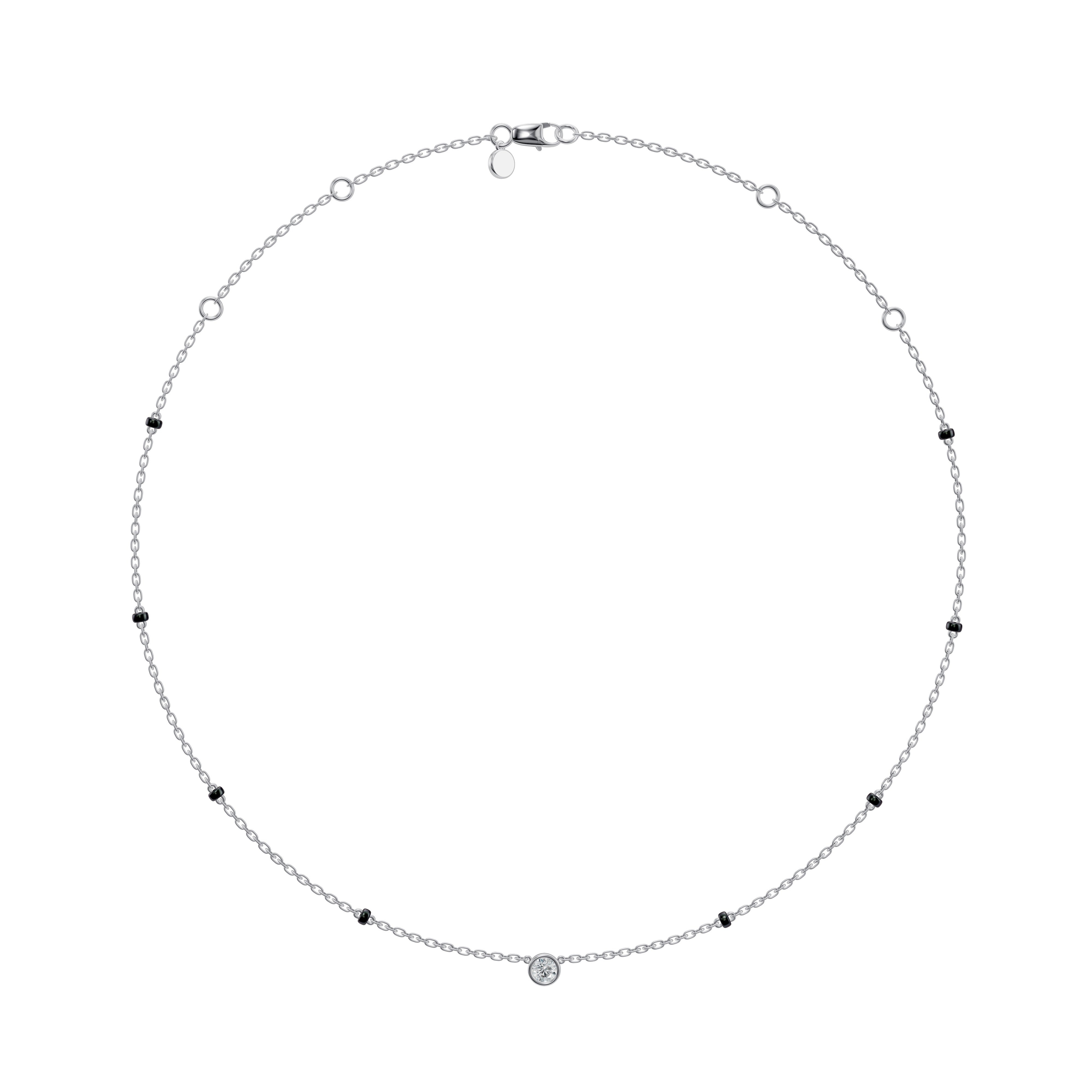 Flat-lay view of the white gold Modern Mangal Minnie Mangalsutra with a centered bezel-set round diamond pendant and evenly spaced black bead chain design.