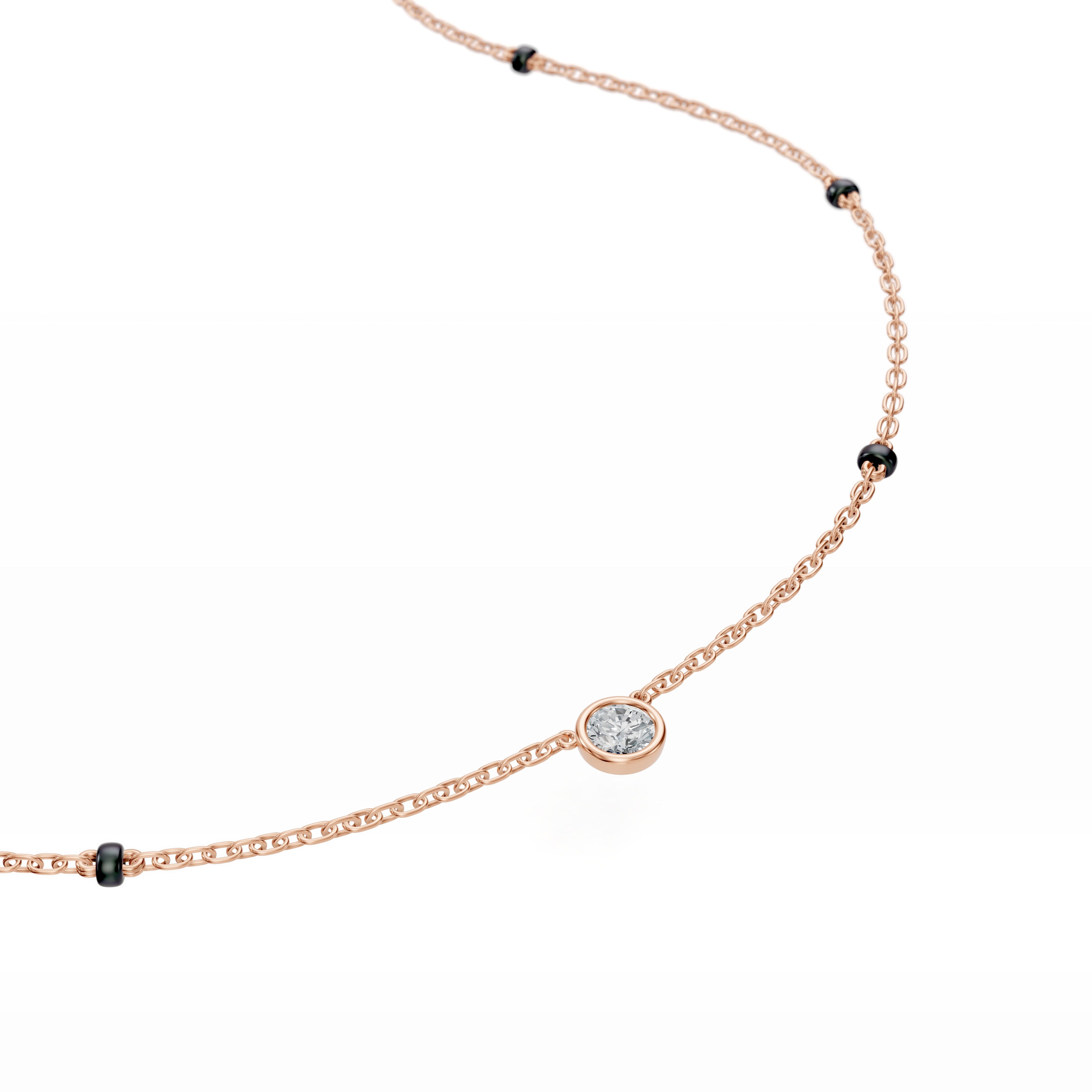 Close-up of the round bezel-set diamond in the Modern Mangal Minnie Mangalsutra, nestled in rose gold with subtle shine and minimal detailing.