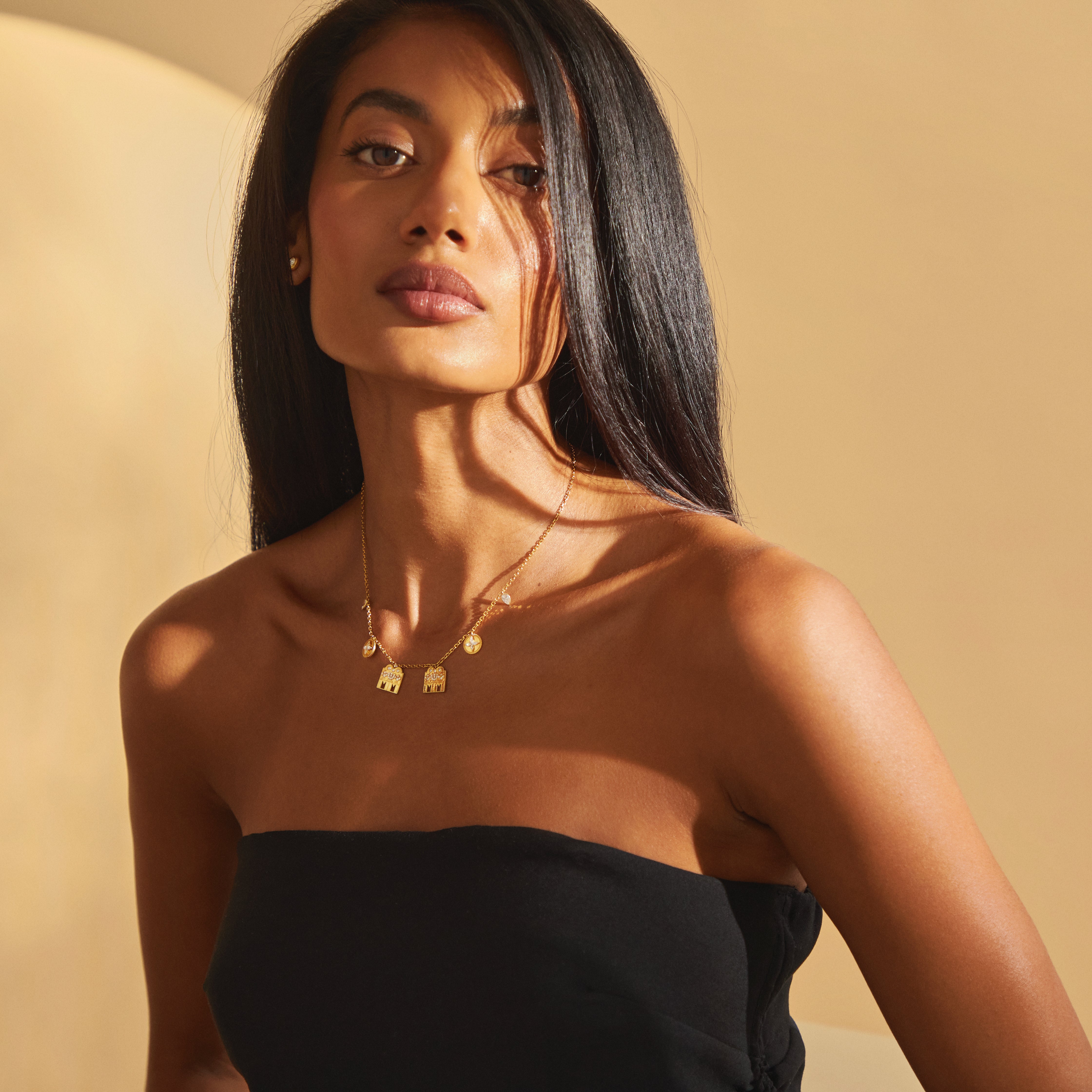 Modern bride styled in the Modern Mangal Monica Mangalayam mangalsutra in yellow gold, showcasing twin Shivling pendants, floral coin charms, and Maavilai bezels that reflect Tamil heritage and contemporary elegance.

