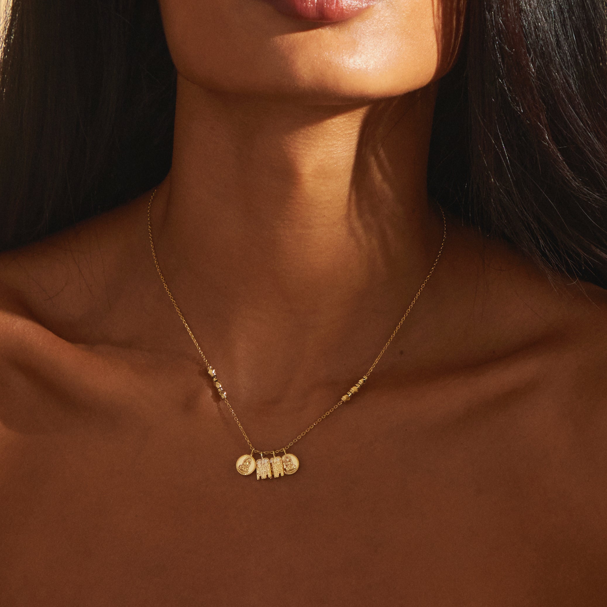 Close-up focus of the Madhura Mangalayam pendant showing detailed tulsi and bottu charms in yellow gold, crafted with FVS2+ lab-grown diamonds on a traditional bead-accented chain.