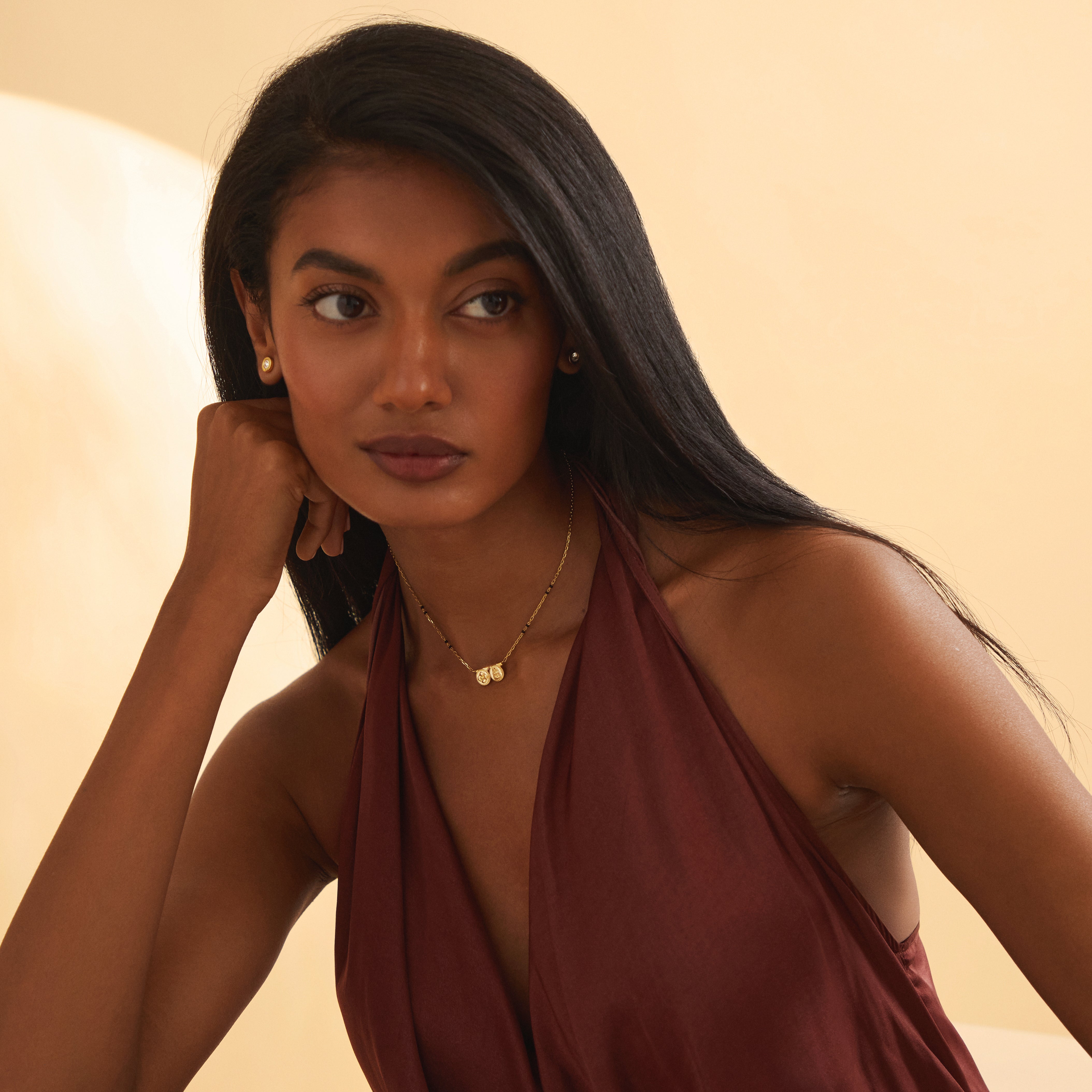 Model showcasing the wide view of the Saanvi Thaali modern mangalsutra in yellow gold, with Duality Chain and two meaningful kasu coins symbolizing marital prosperity and grace.