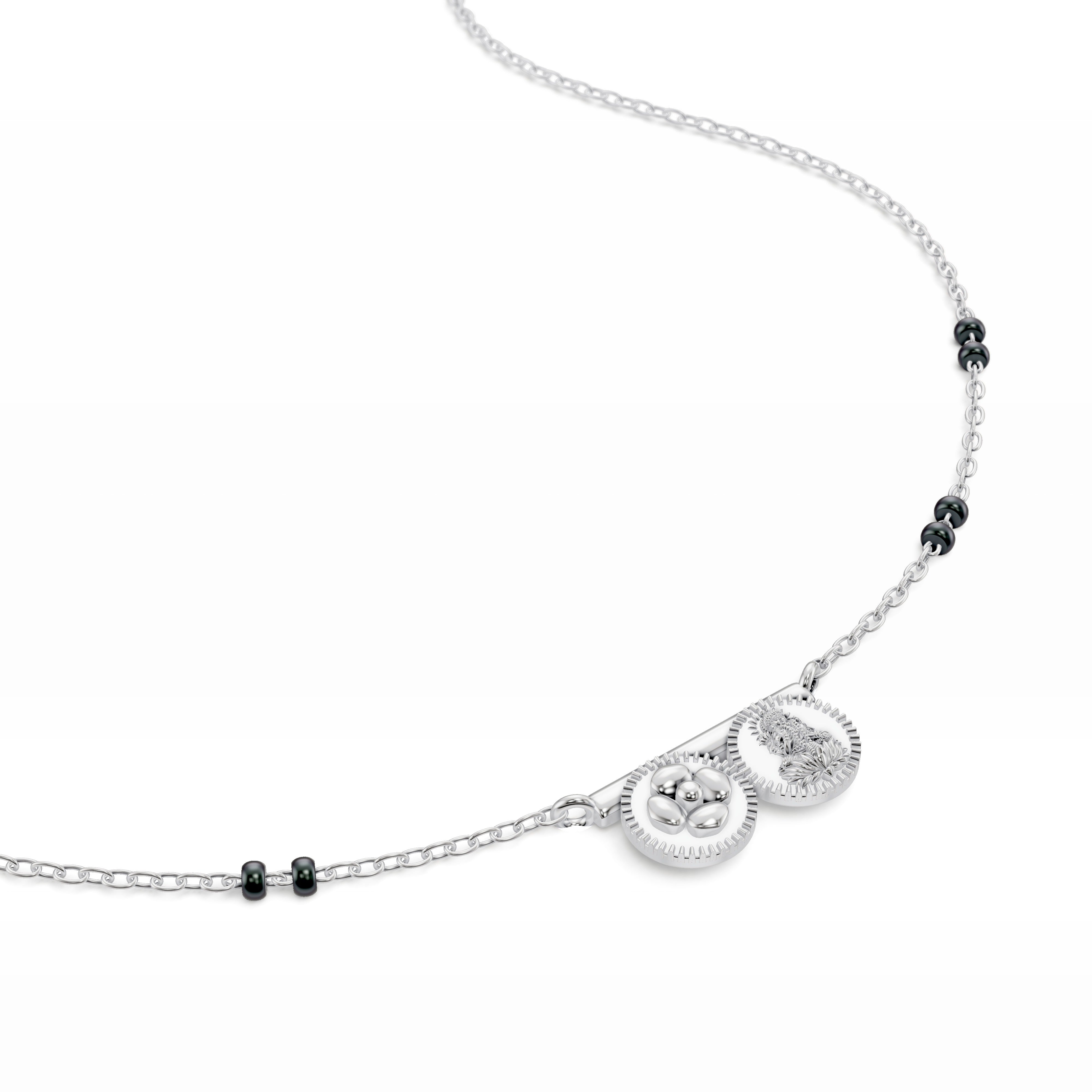 Detail of the white gold Modern Mangal Saanvi Thaali pendant showing the Lakshmi and pushpa kasu elements, elegantly mounted on a gold bar to reflect Telugu cultural tradition.