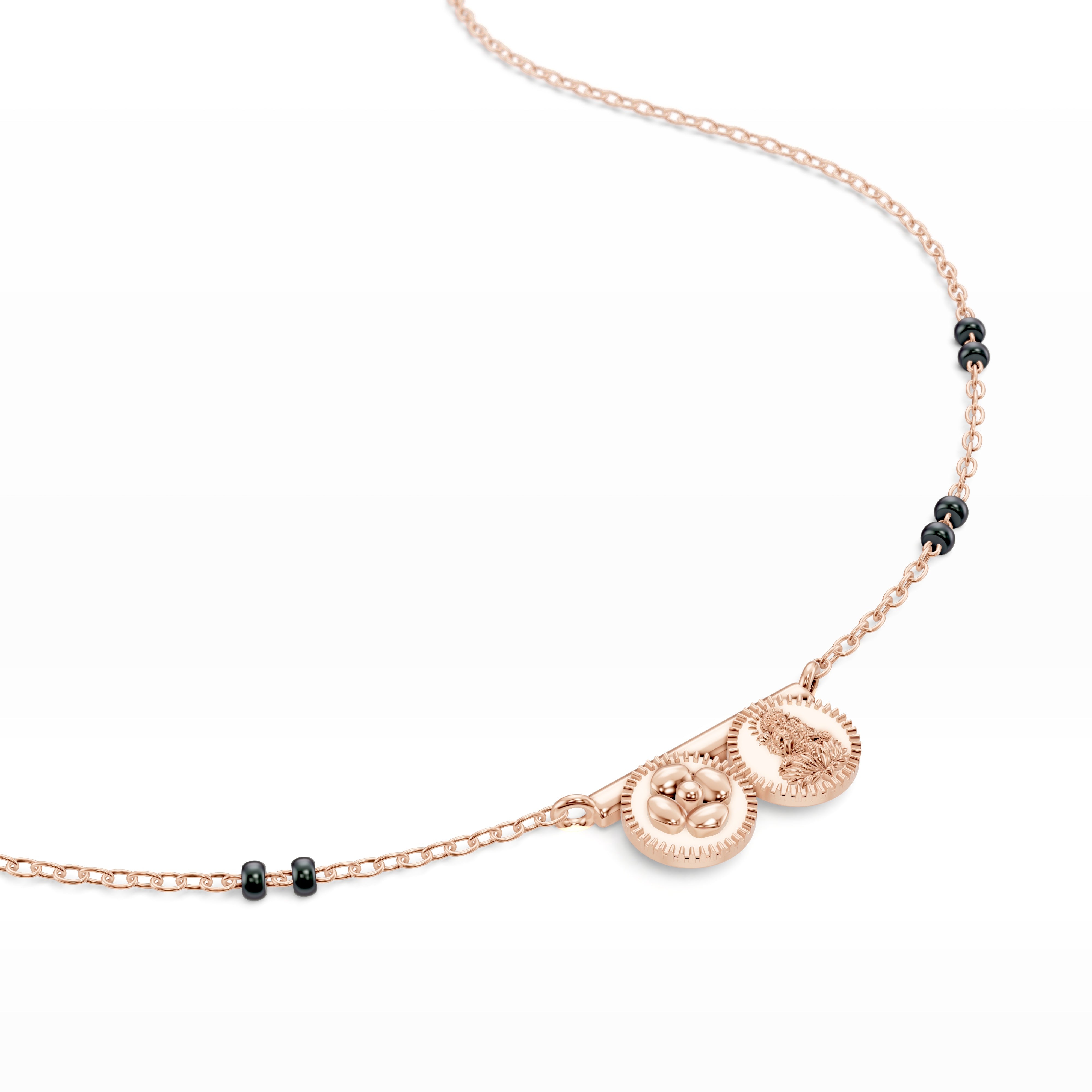 Close-up image of the Modern Mangal Saanvi Thaali pendant in 18K rose gold featuring the pushpa kasu and Lakshmi kasu coins fixed along a sleek gold bar in tribute to Telugu tradition.