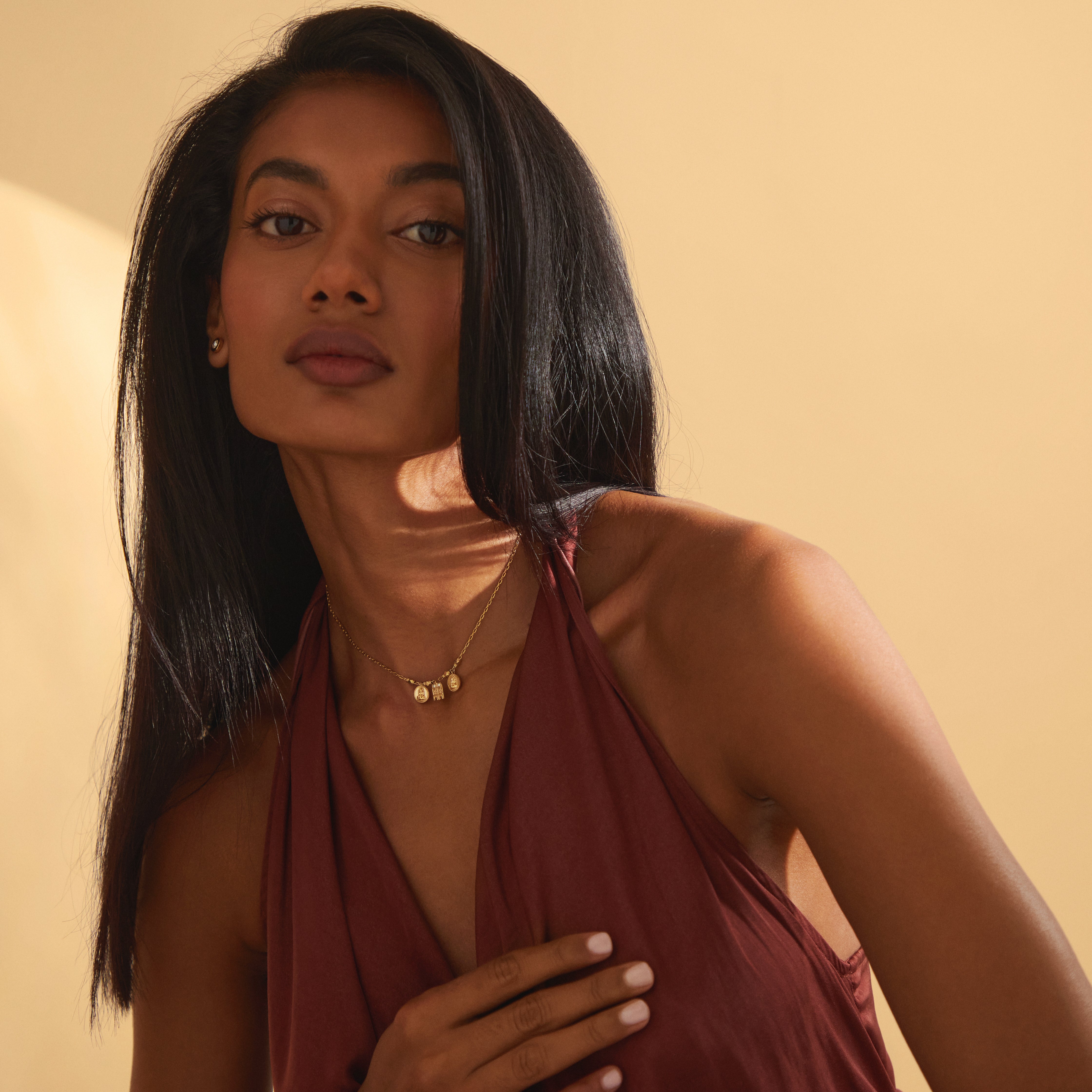 The Sriya Mangalayam yellow gold necklace worn by a model in a wide view, highlighting its balanced design with a Tamil mangalayam and Lakshmi kasu coins, embodying South Indian tradition through modern mangal style.