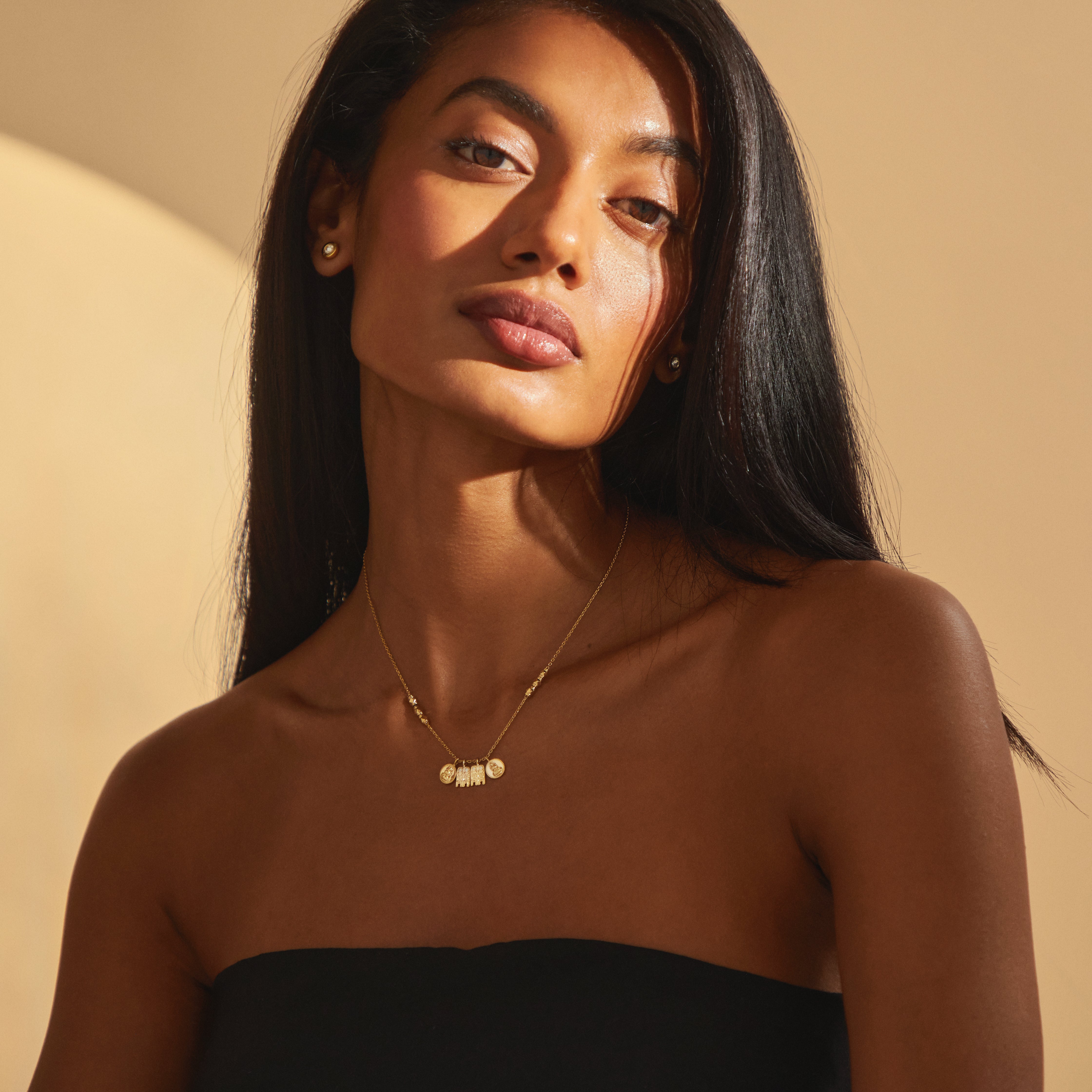 Elegant view of the Madhura Mangalayam in yellow gold, styled on a model, showcasing temple-inspired gold beads and sacred South Indian pendant charms for modern brides.