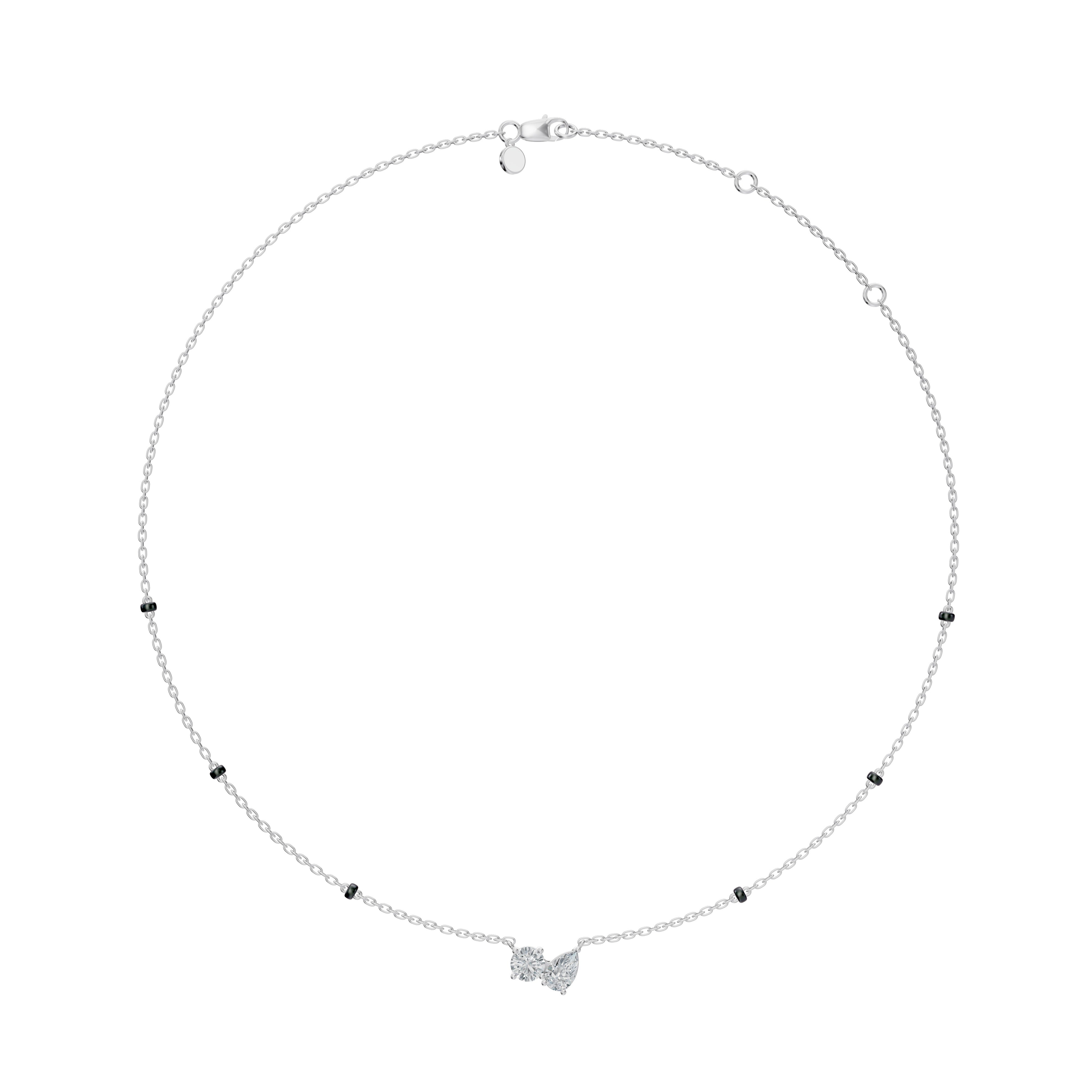 Full view of the Modern mangal Amari Mangalsutra in white gold, with black beads spaced on twin strands and a gracefully balanced pear and round diamond pendant.