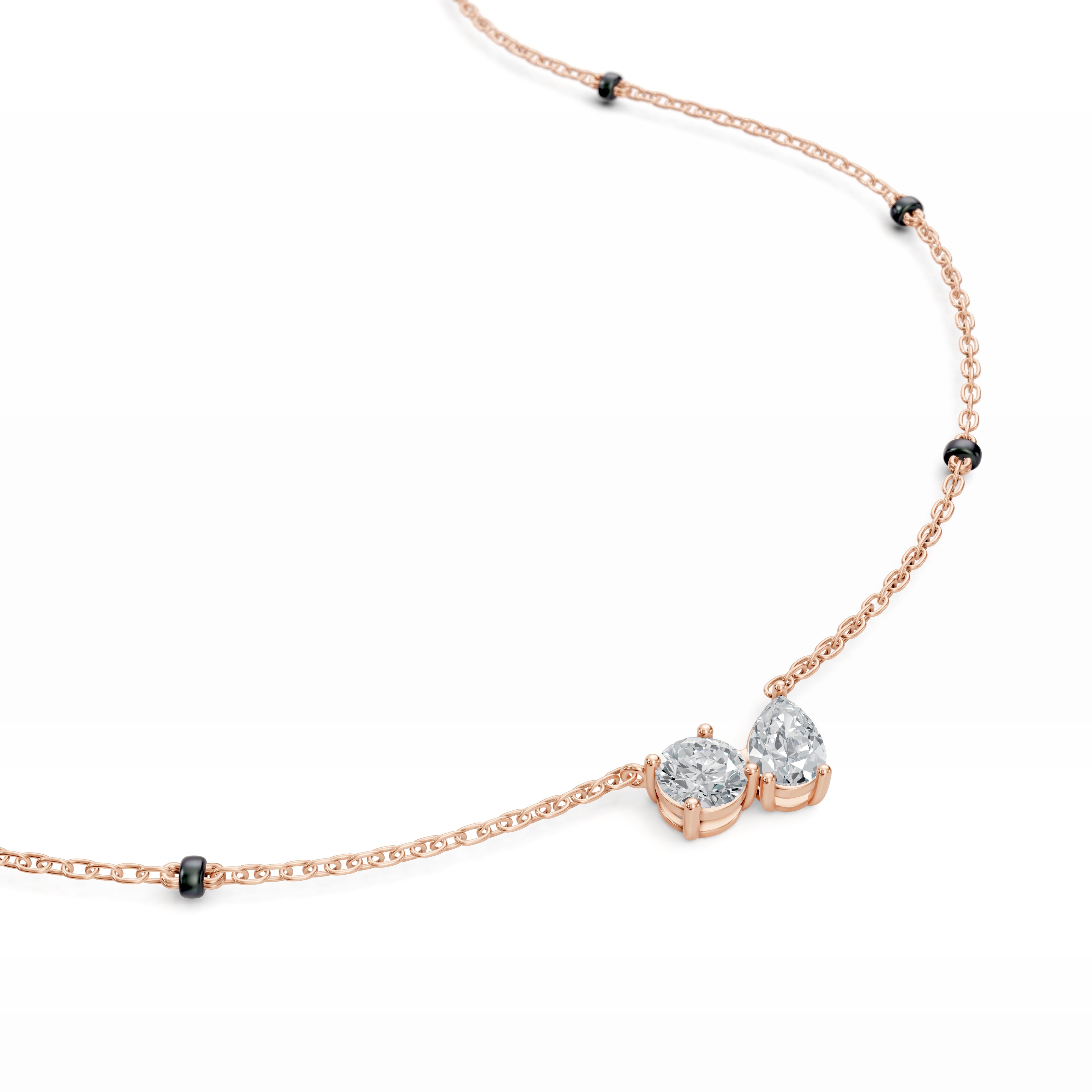 Close-up of the rose gold Modern mangal Amari pendant, focusing on the Toi et Moi composition—one pear diamond and one round diamond in perfect harmony.