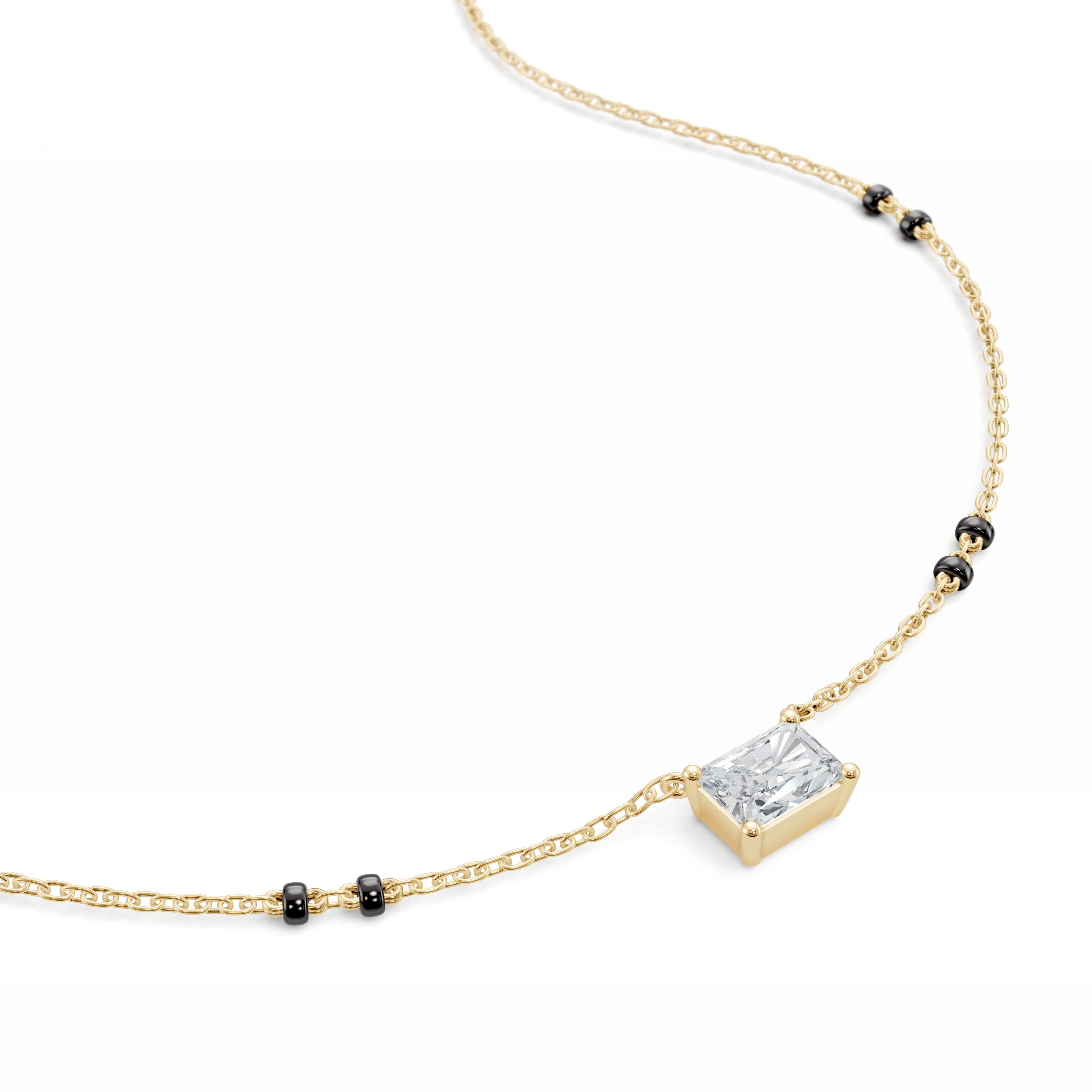 Close-up of the yellow gold Modern Mangal Radhi pendant, showing the east-west set radiant-cut diamond with a bold, geometric sparkle.