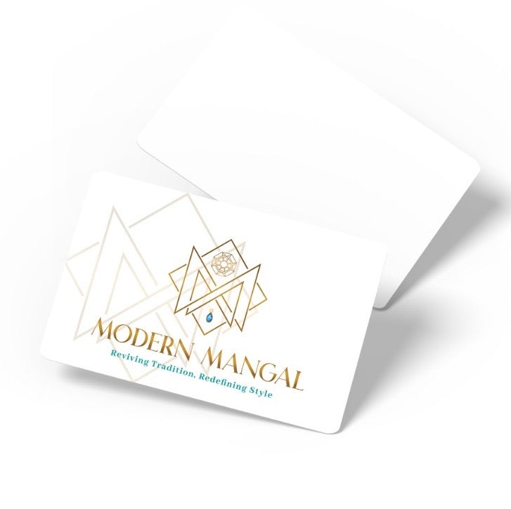 Modern Mangal gift card: two white cards on a pale background, the front showing the gold Modern Mangal emblem of interlocking triangles set with a faceted round stone and a small teal drop, above the wordmark and the line Reviving Tradition, Redefining Style.