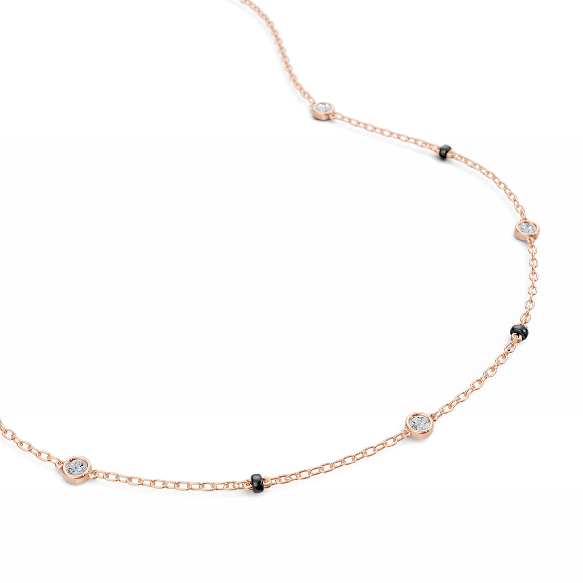 Close-up of the five bezel-set lab-grown diamonds on the Alia Mangalsutra in 18K rose gold