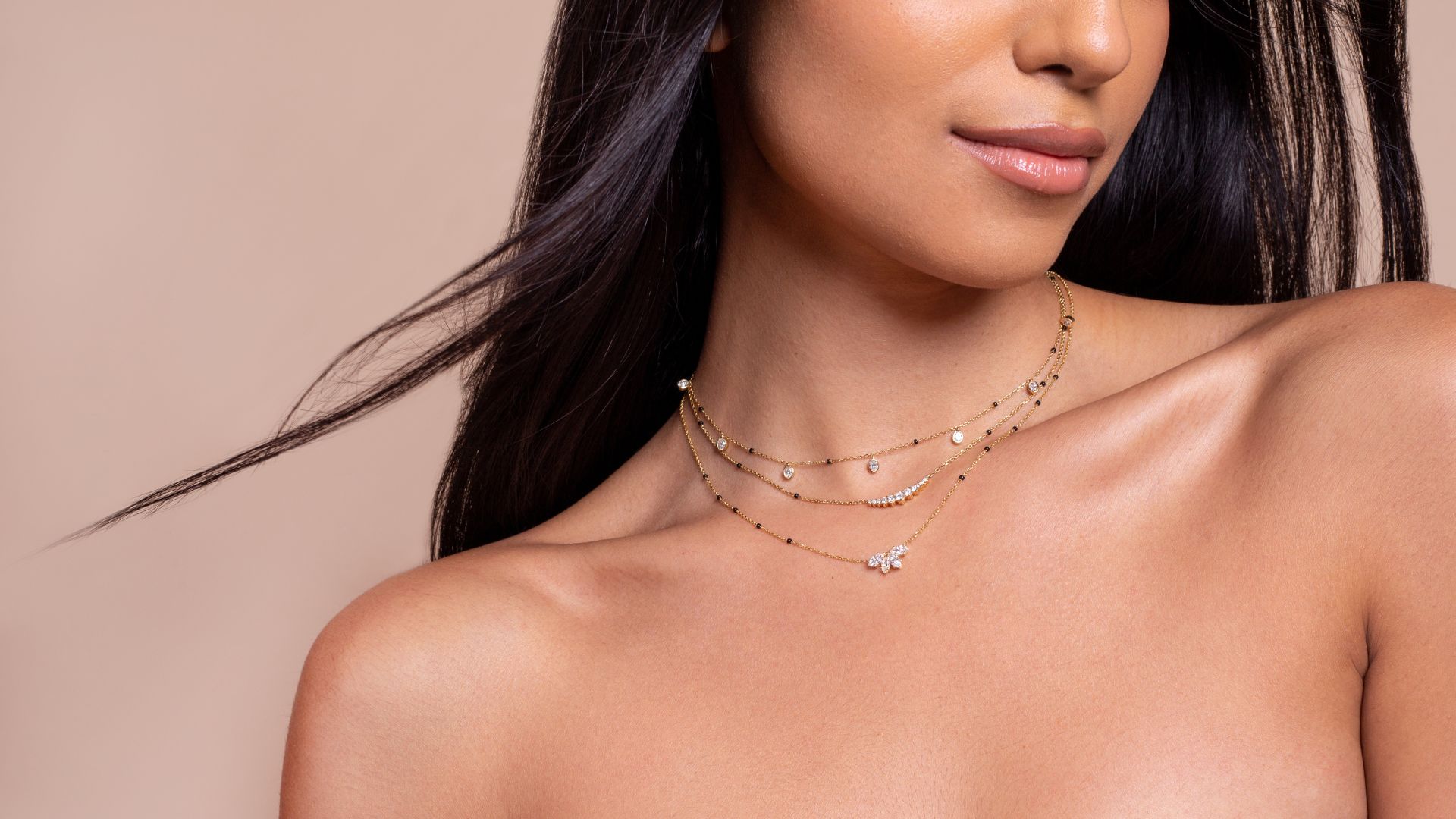 Close-up of a model wearing layered necklaces from the Modern Mangal x Ashna Gray Ashna Collection. The pieces showcase a blend of traditional mangalsutra elements with a modern design, crafted to be versatile and timeless.