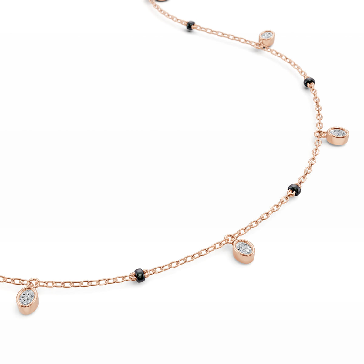 Close-up of the dangling bezel-set oval lab-grown diamond on the Ashna Mangalsutra in 18K rose gold