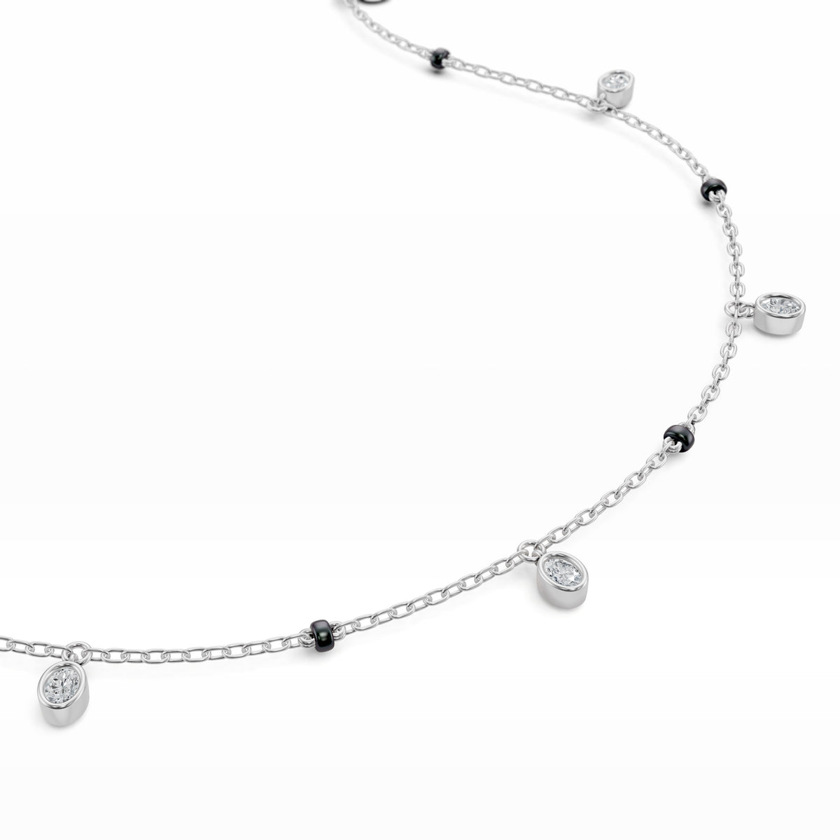 Close-up of the dangling bezel-set oval lab-grown diamond on the Ashna Mangalsutra in 18K white gold