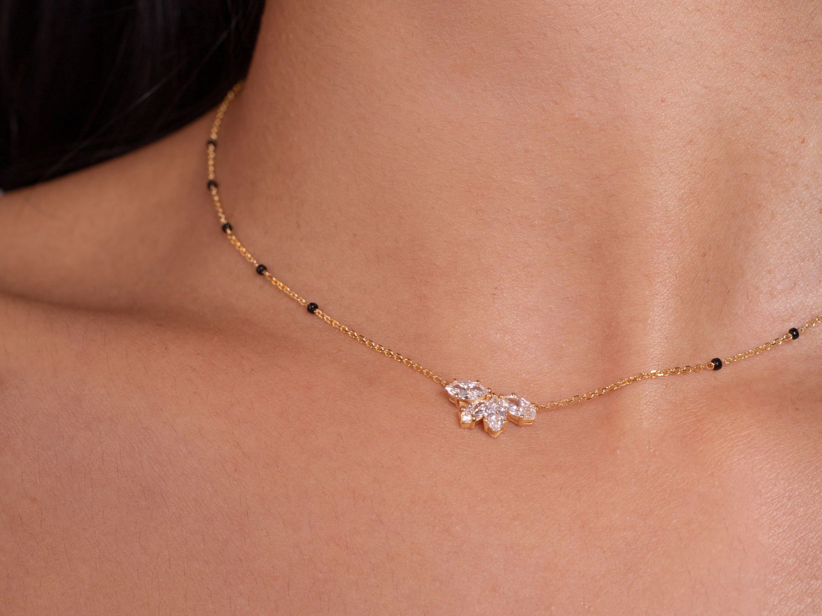 Close-up of the Love in Bloom Necklace from the Modern Mangal x Ashna Gray Collection, featuring a floral-inspired pendant on a fine gold chain, symbolizing grace and modern femininity.