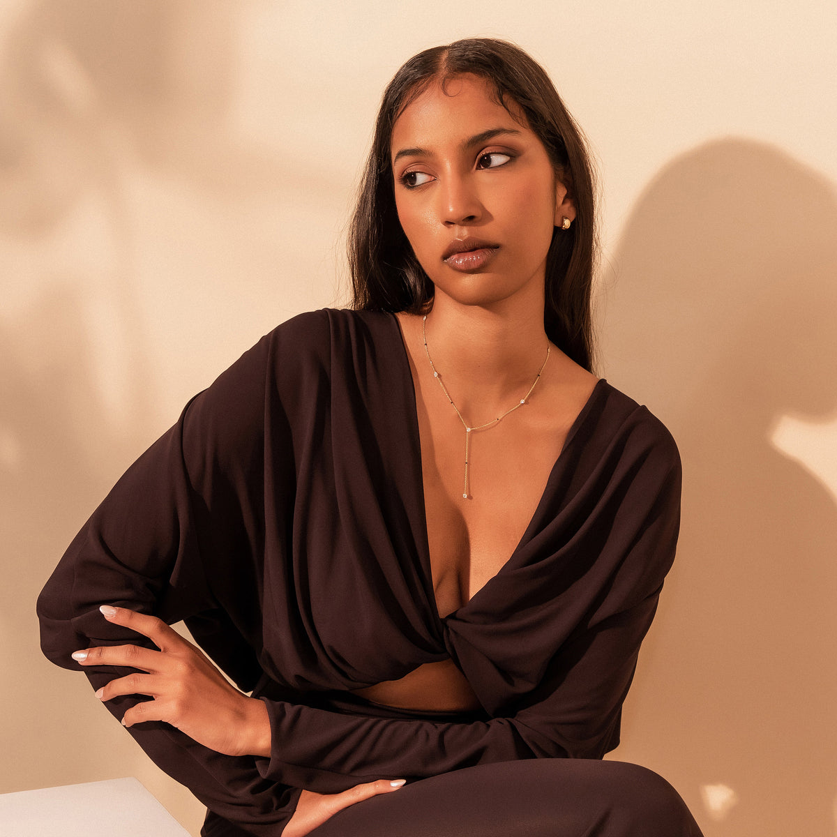 Model wearing the Mila Mangalsutra, an 18K gold lariat with bezel-set diamonds and black beads