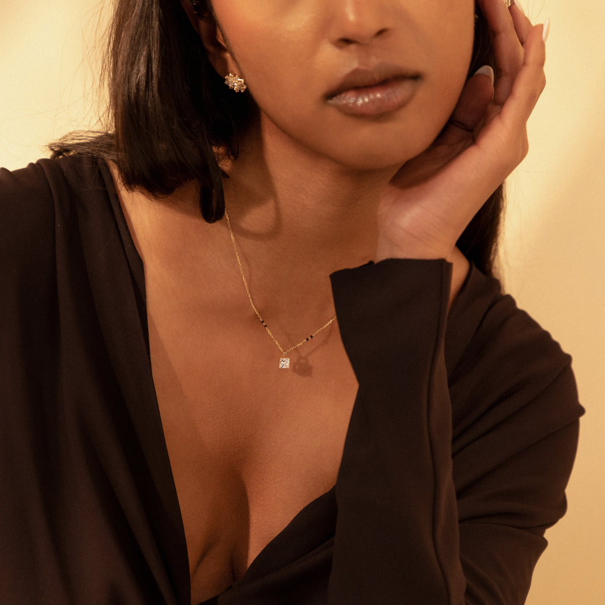 Angled view of model wearing the Nehal Mangalsutra, highlighting the sparkle of the princess diamond against a deep neckline.