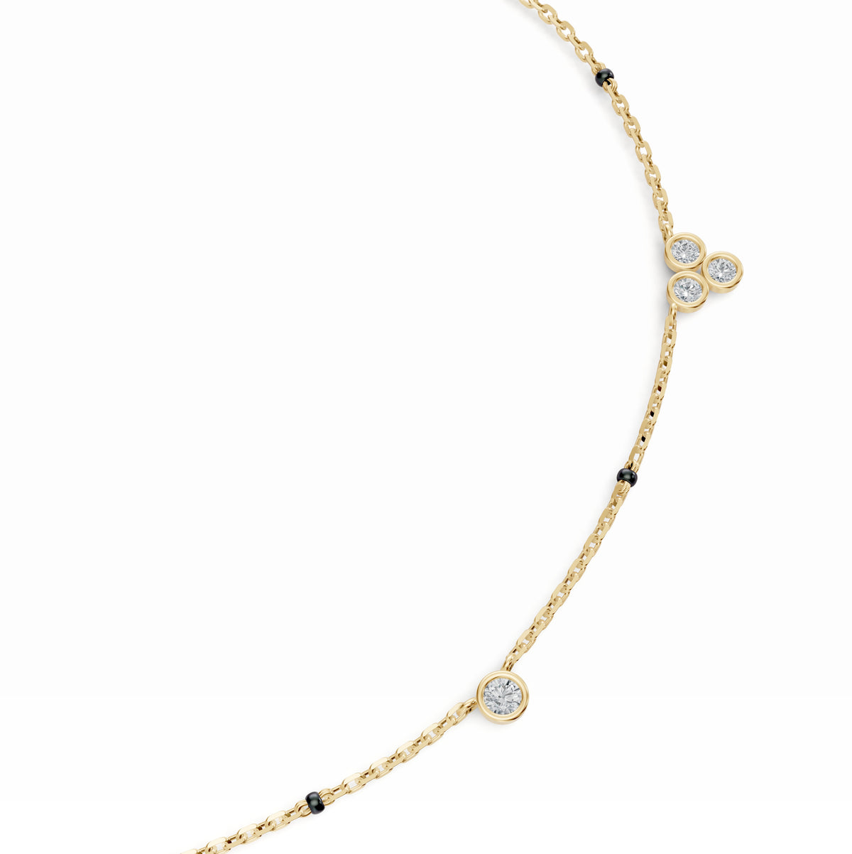 Close-up of the bezel-set diamond stations on the Nidhi Mangalsutra in 18K yellow gold