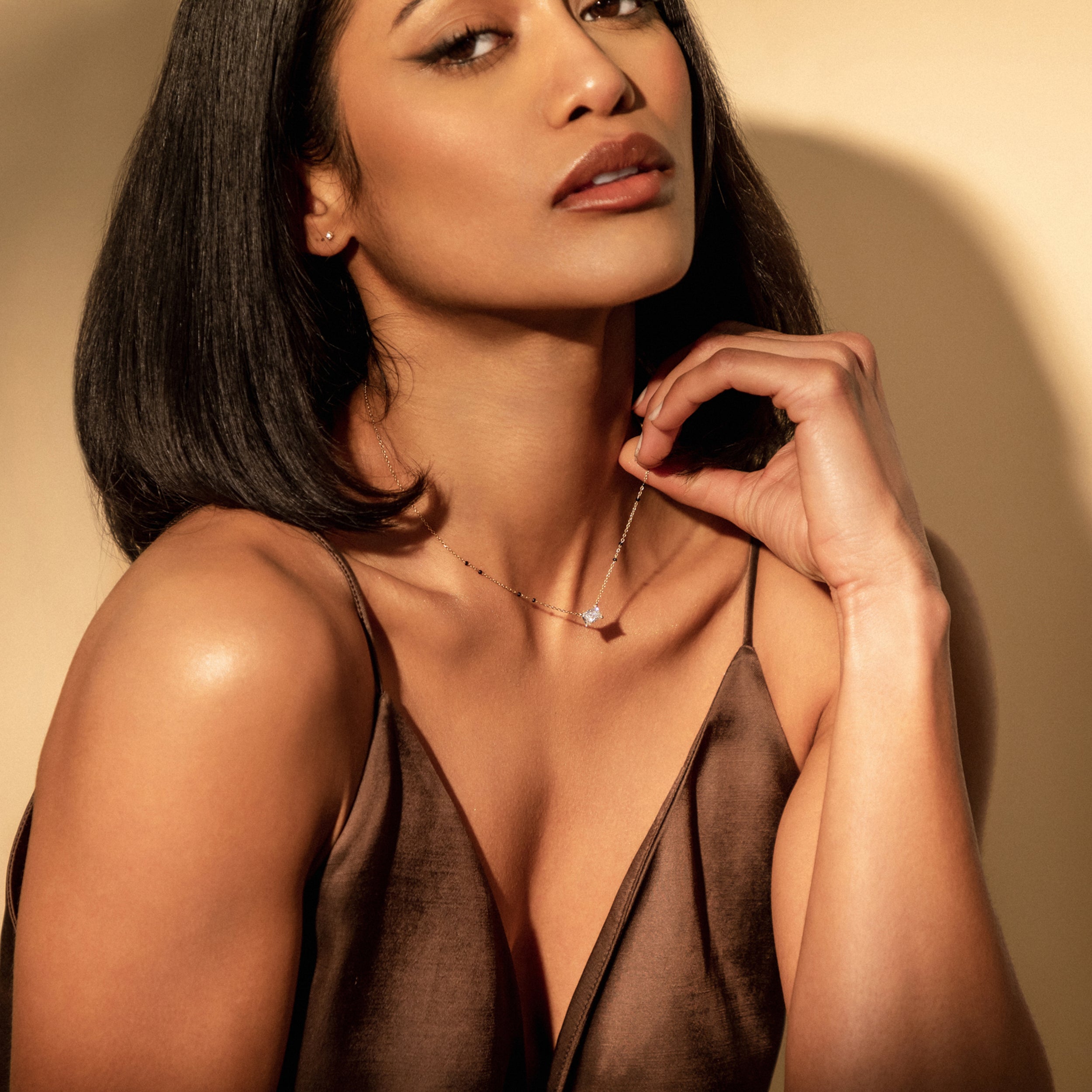 Angled view of model wearing the Modern Mangal Radhi Mangalsutra, highlighting the sparkle of the radiant diamond and the delicate beaded chain design.