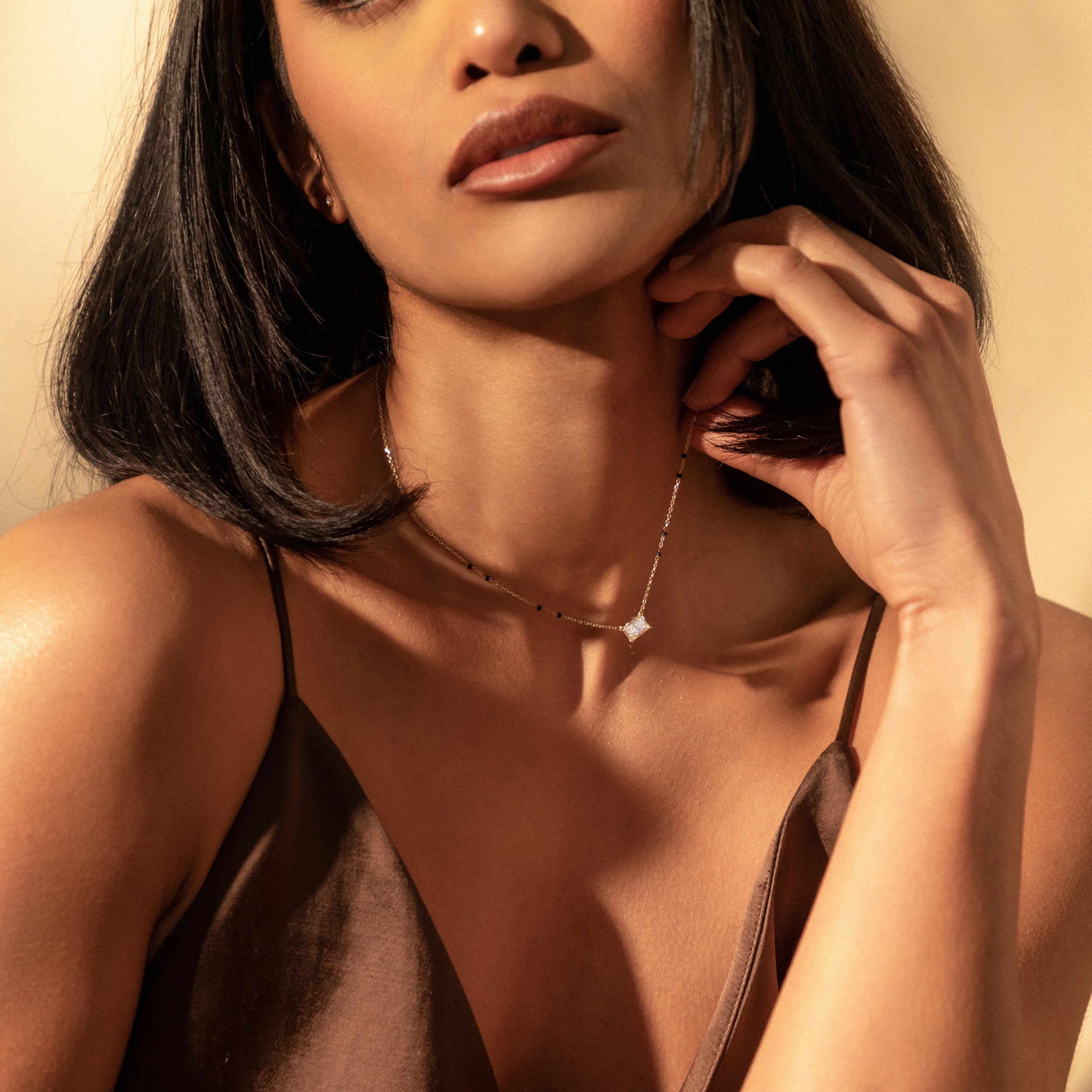 Close-up side view of model wearing the Modern Mangal Radhi Mangalsutra, with the radiant diamond pendant catching the light beautifully.