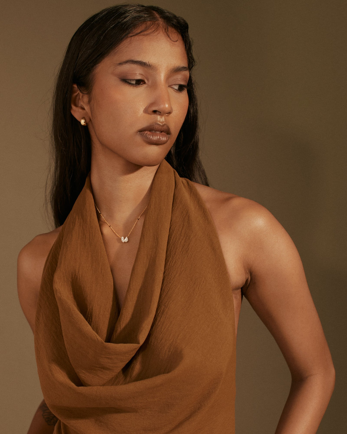 A model in a mocha draped top wearing a fine gold mangalsutra, Barcelona shoot