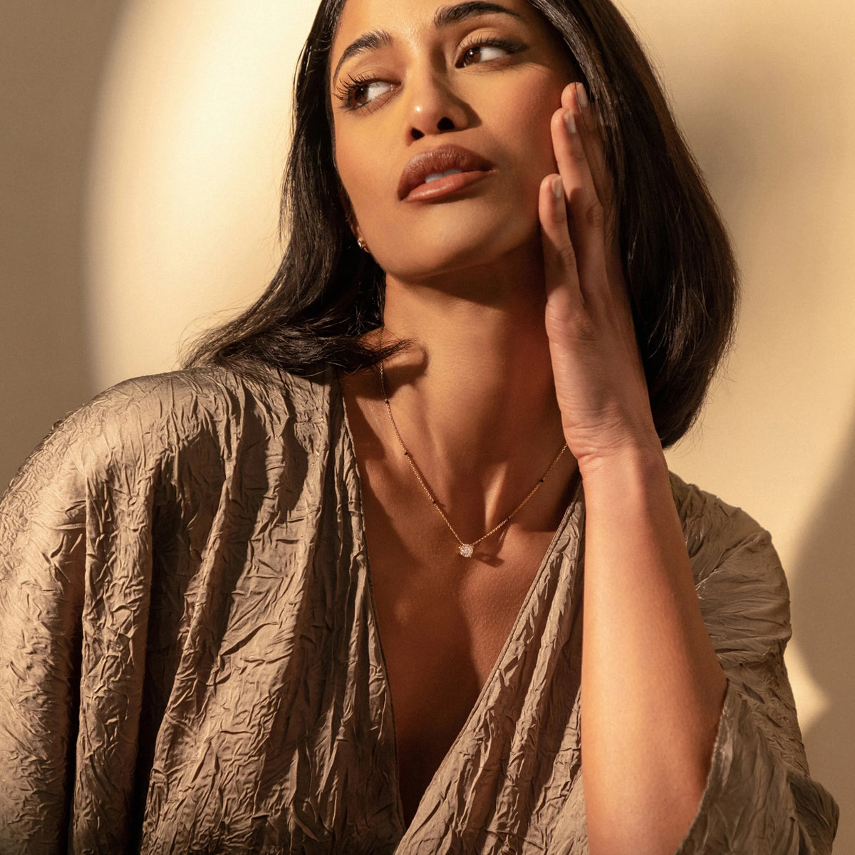 Angled view of model wearing the Roshni Mangalsutra, highlighting how the round diamond pendant shimmers against the skin.