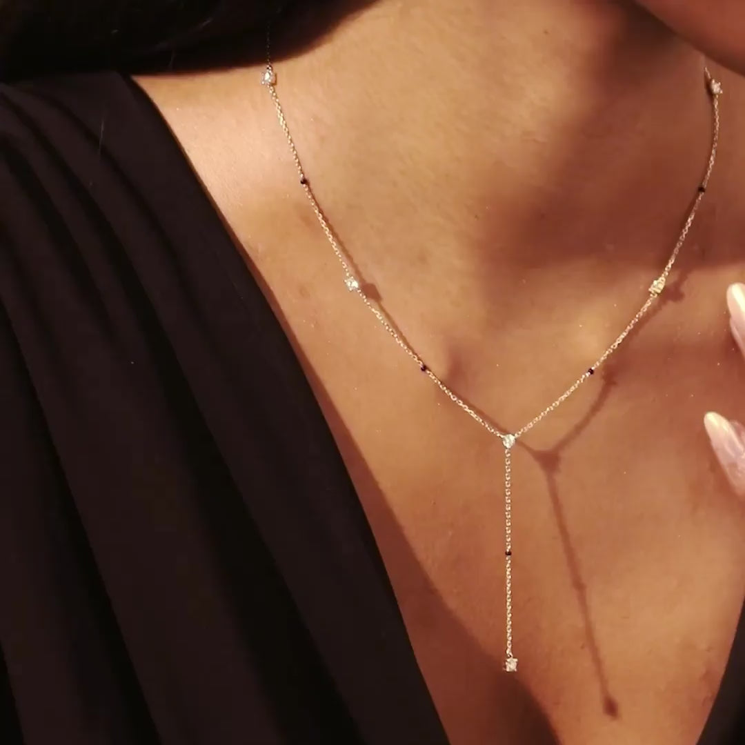 Model video of the yellow gold Modern Mangal Mila Mangalsutra in motion, capturing the graceful sway of the lariat-style chain and diamond station sparkle.