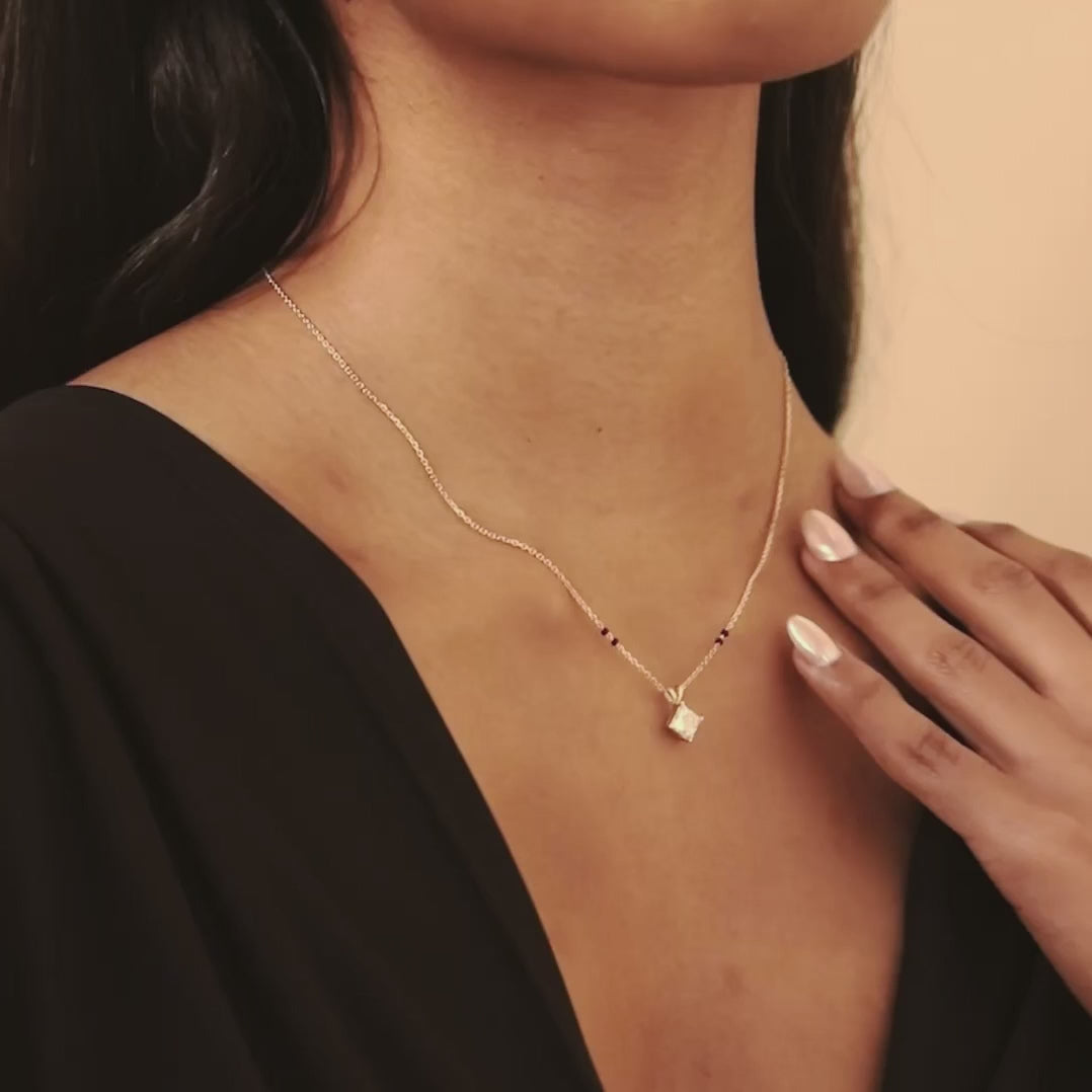 Video of a model in motion wearing the Modern Mangal Zara Mangalsutra in yellow gold, highlighting the elegant diamond pendant swinging gently from the bail.