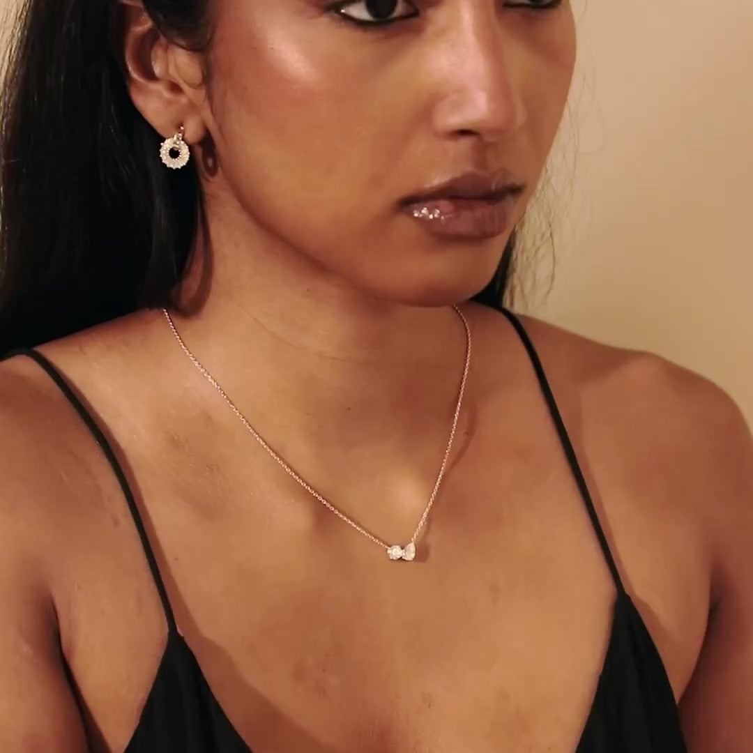 Model video showing the Modern Mangal yellow gold Leila Necklace Mangalsutra in motion, with light playing off the pear and round diamonds as the model moves gracefully.