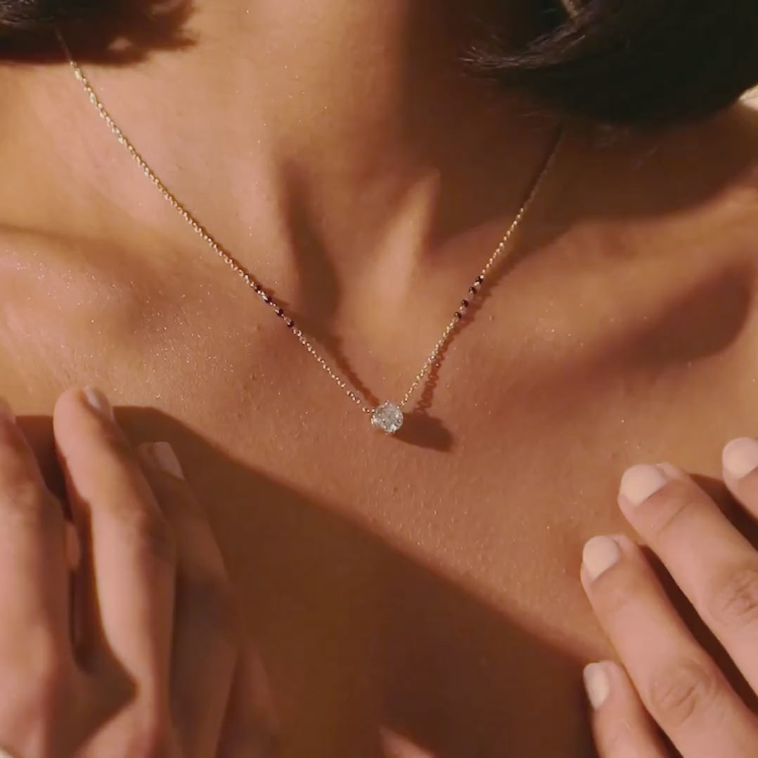 Video of the Model  wearing the modern mangal Anahi Mangalsutra in yellow gold, showing the sparkle of the round diamond and the elegant spacing of the bead chain.
