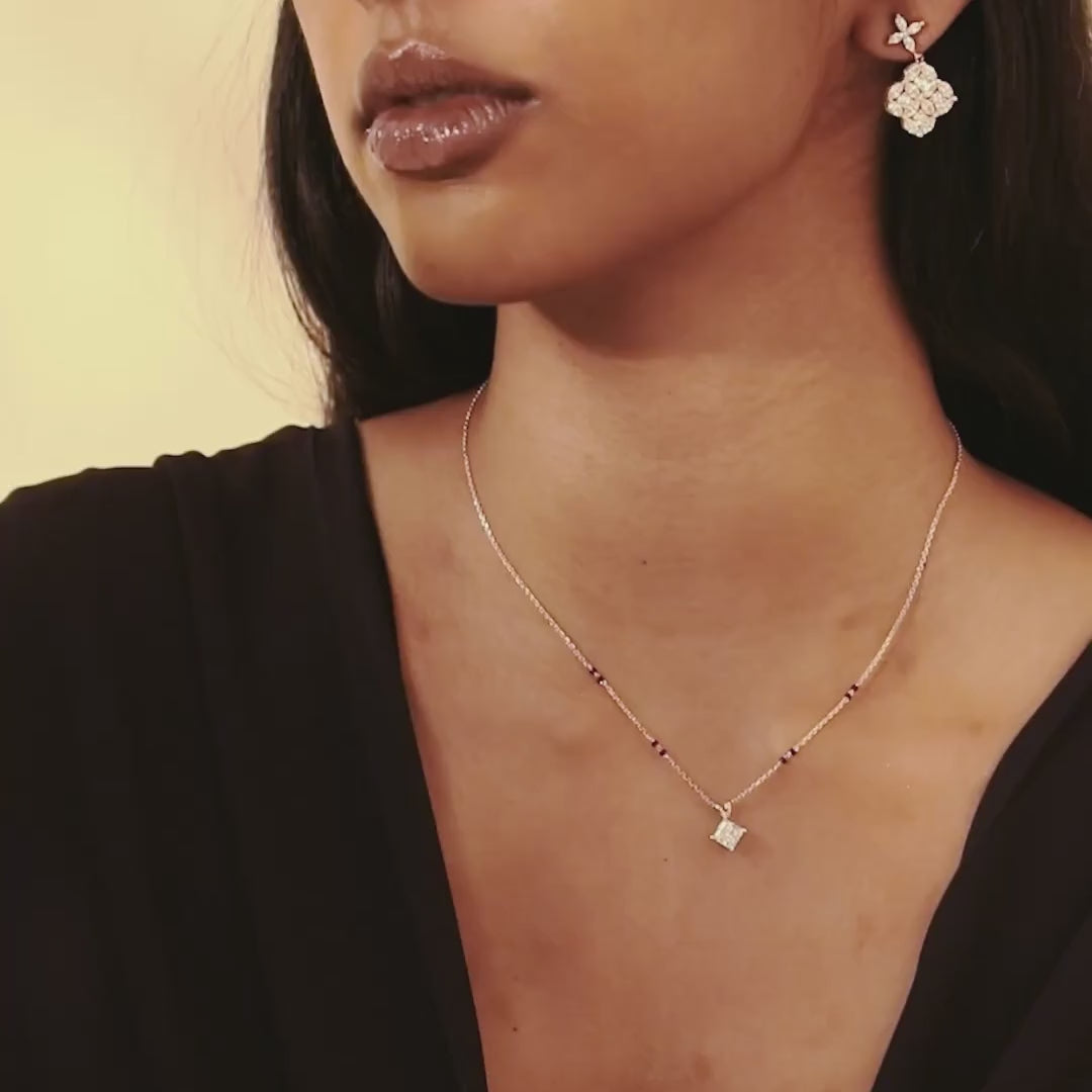Lifestyle video of a model wearing the Modern Mangal Yellow Gold Aayushi Mangalsutra, with the princess diamond pendant catching light as it moves subtly.